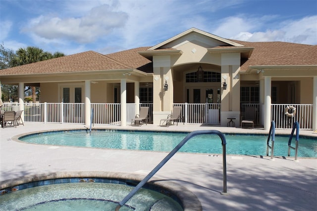 view of pool featuring a hot tub and a patio