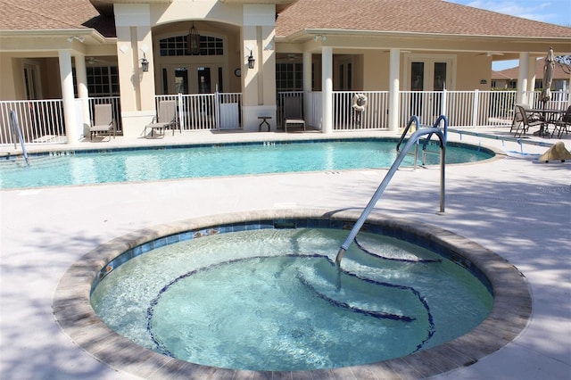 view of pool featuring a hot tub and a patio