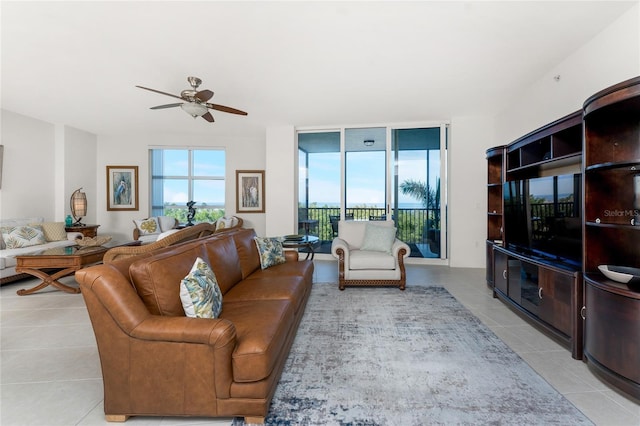 tiled living room with a wall of windows and ceiling fan