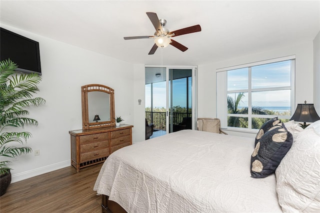 bedroom featuring ceiling fan, dark hardwood / wood-style flooring, multiple windows, and access to outside