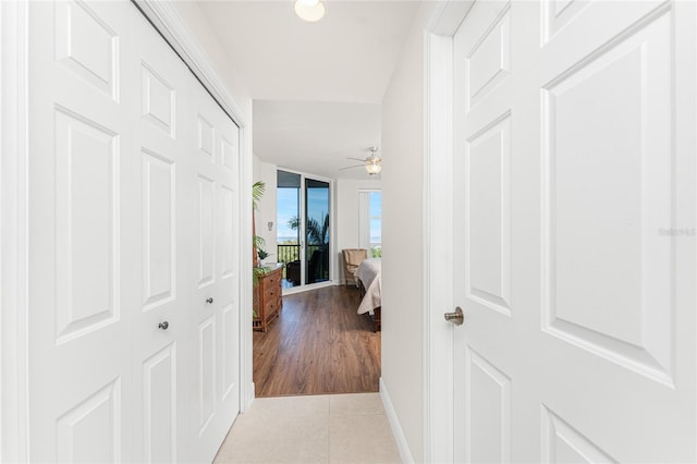 hall with light tile patterned floors