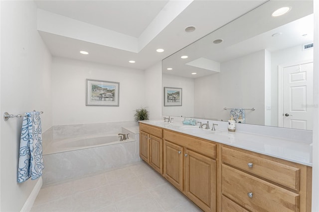 bathroom with vanity, a washtub, and tile patterned floors