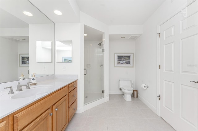 bathroom featuring tile patterned flooring, vanity, a shower with shower door, and toilet