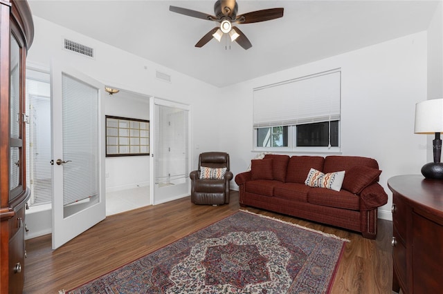 living room with ceiling fan and dark hardwood / wood-style floors