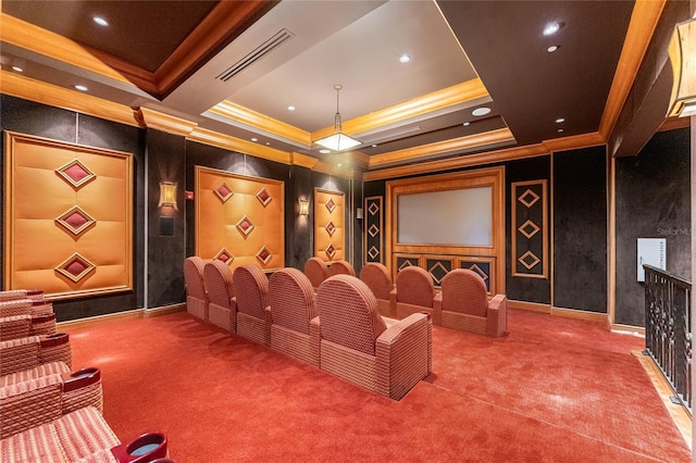 cinema featuring ornamental molding, a raised ceiling, and carpet flooring