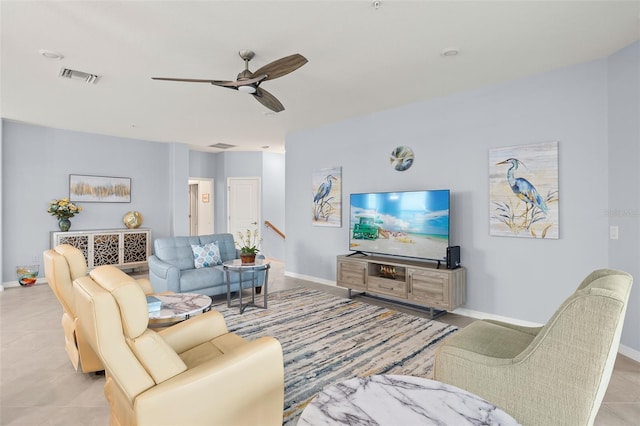 tiled living room with ceiling fan