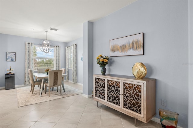 dining area with an inviting chandelier and light tile patterned floors