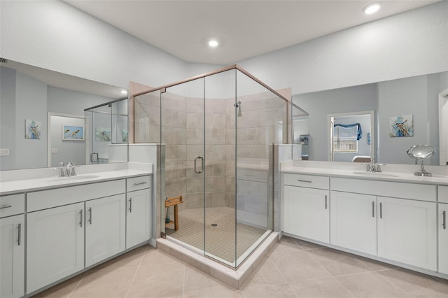 bathroom with vanity, a shower with shower door, and tile patterned flooring