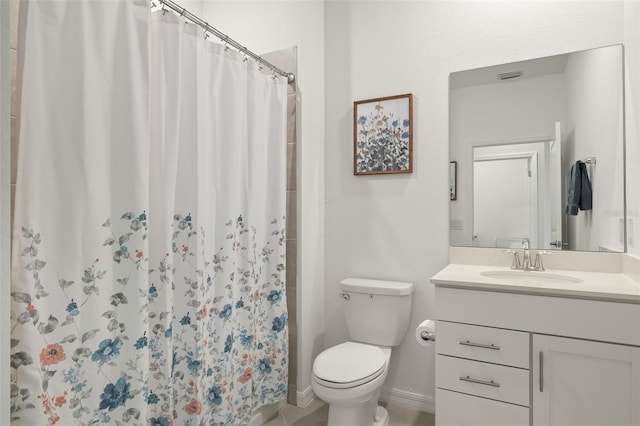 bathroom with vanity, curtained shower, and toilet