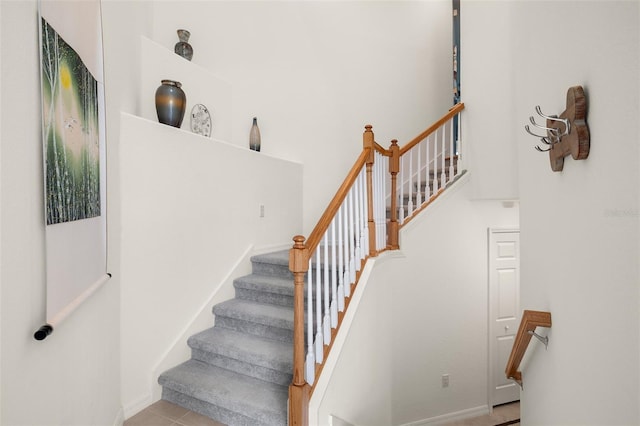 stairway with tile patterned flooring