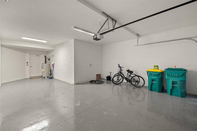 garage featuring a garage door opener and water heater