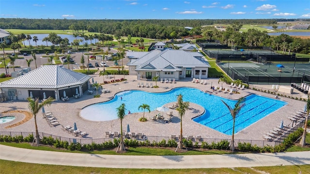 view of pool featuring a water view and a patio