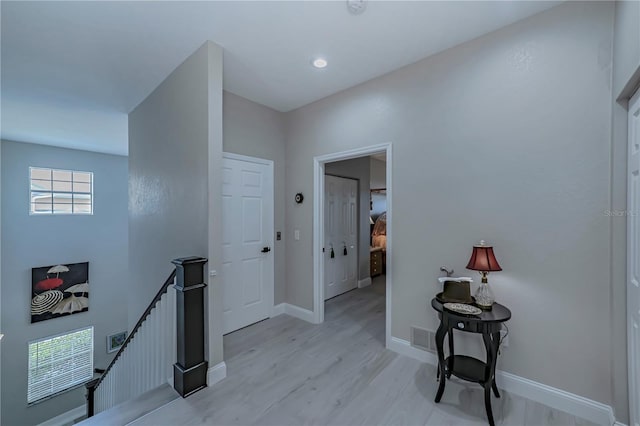 hallway with light hardwood / wood-style flooring