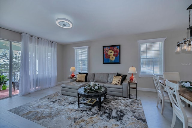 living room with light hardwood / wood-style floors and a healthy amount of sunlight