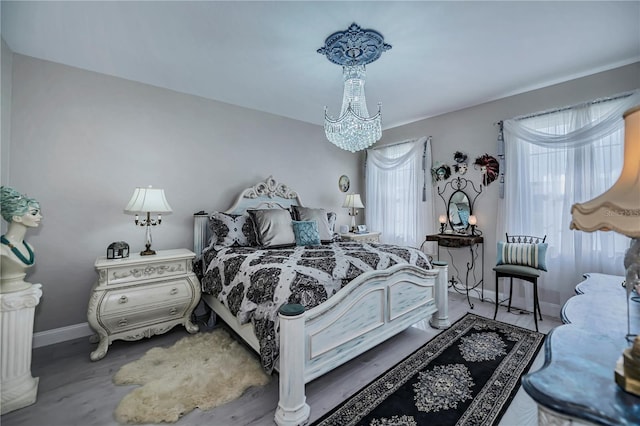 bedroom with a chandelier and hardwood / wood-style floors