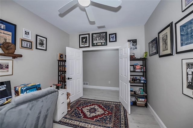 office space with light hardwood / wood-style floors and ceiling fan