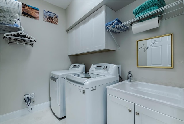 washroom featuring washer and dryer and cabinets