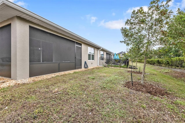 view of yard featuring a sunroom