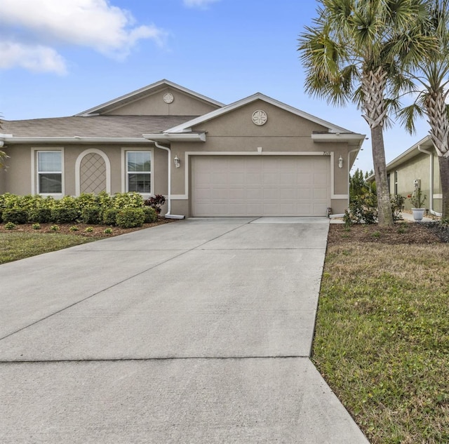 ranch-style home featuring a garage and a front lawn