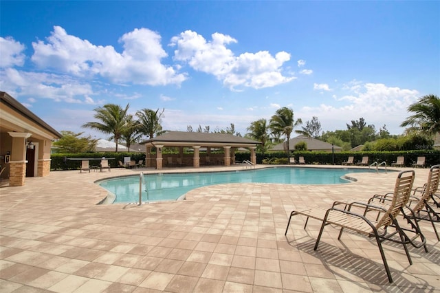 view of swimming pool featuring a gazebo and a patio