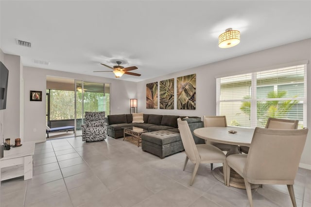 tiled dining space featuring ceiling fan