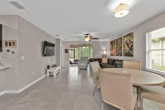 tiled dining area featuring ceiling fan