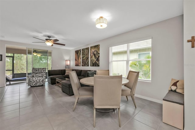 tiled dining space with a wealth of natural light and ceiling fan