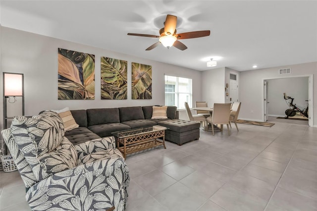 living room with light tile patterned floors and ceiling fan