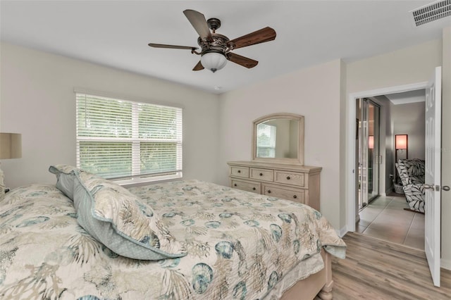 bedroom with ceiling fan and light wood-type flooring