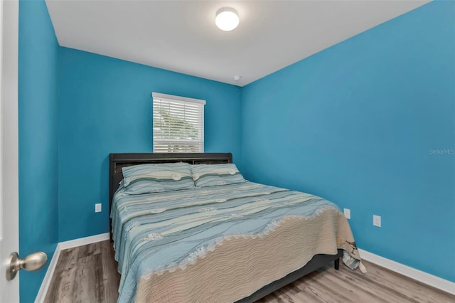 bedroom with hardwood / wood-style flooring