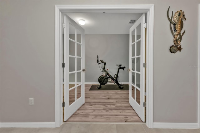 interior space featuring light tile patterned floors and french doors