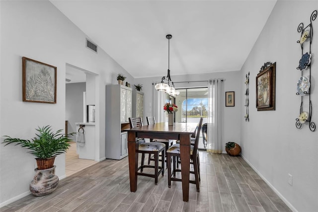 dining room featuring lofted ceiling