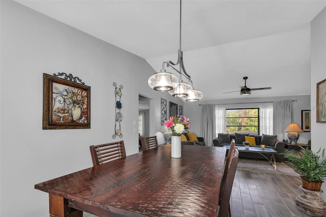 dining space with hardwood / wood-style floors, vaulted ceiling, and ceiling fan