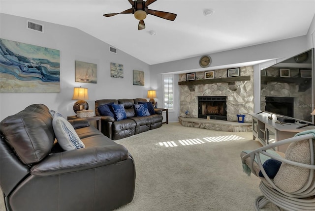 living room with ceiling fan, carpet, vaulted ceiling, and a fireplace