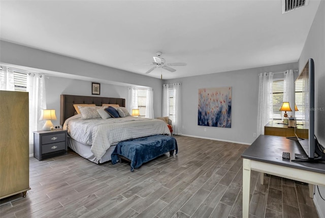 bedroom with multiple windows and ceiling fan