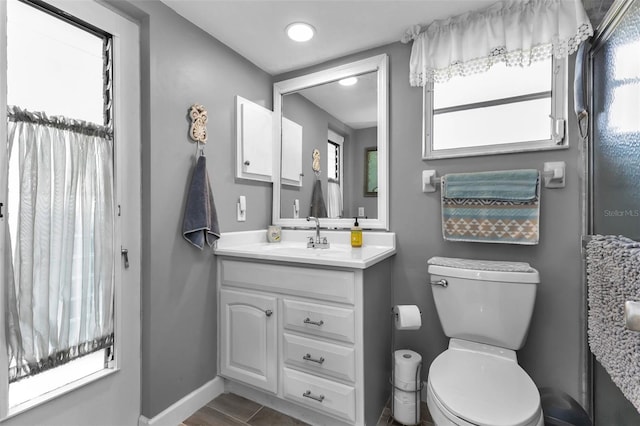 bathroom featuring toilet and vanity