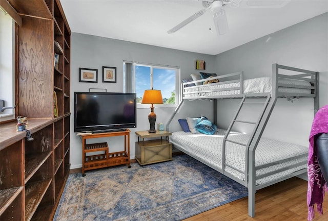 bedroom with ceiling fan and hardwood / wood-style flooring