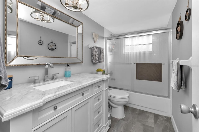 full bathroom featuring shower / bath combination with glass door, vanity, and toilet