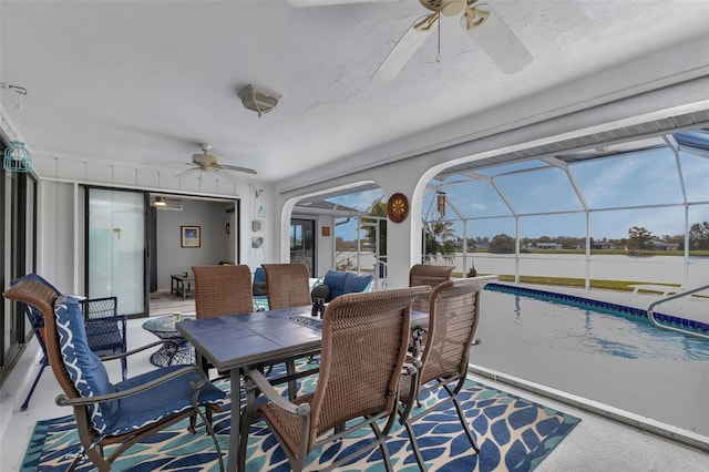 sunroom / solarium featuring ceiling fan