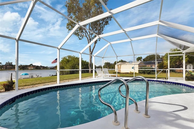 view of pool featuring a water view, glass enclosure, a lawn, and a patio area