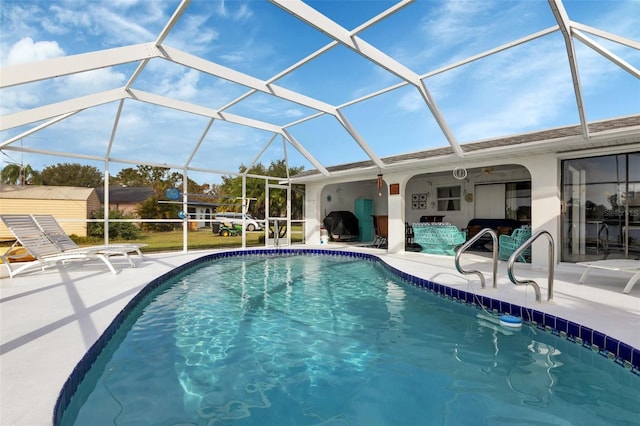 view of swimming pool featuring a lanai and a patio area