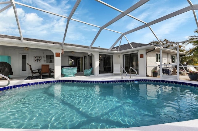 view of pool with ceiling fan, a patio area, grilling area, and a lanai