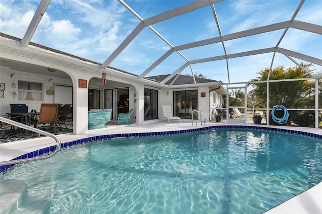 view of swimming pool featuring a patio and a lanai