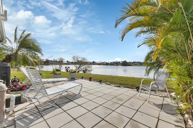 view of patio with cooling unit and a water view