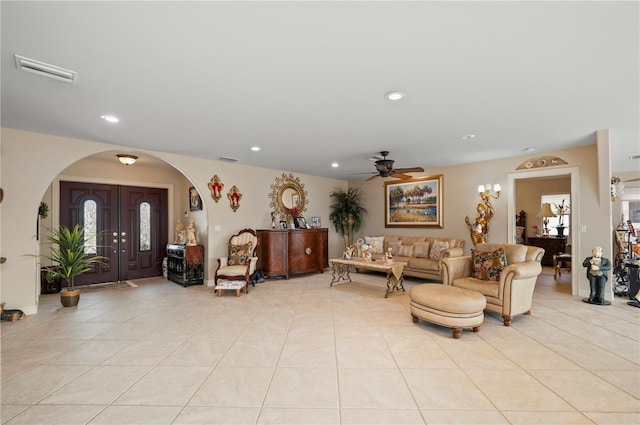 tiled living room with ceiling fan