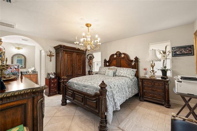 tiled bedroom featuring a notable chandelier