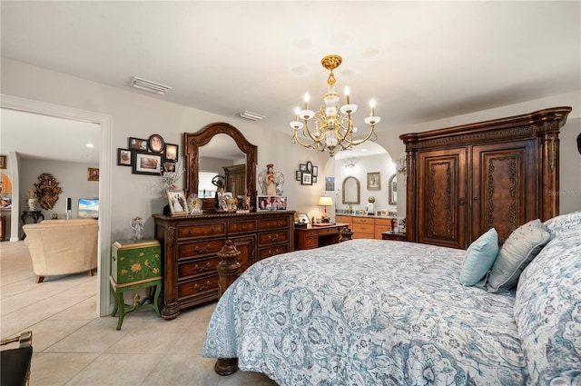 bedroom featuring a chandelier and light tile patterned flooring