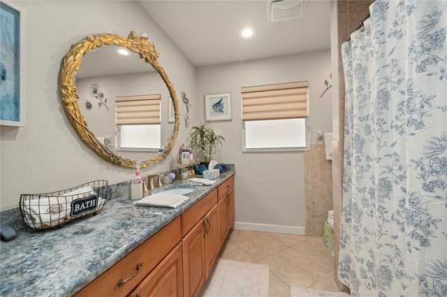 bathroom with curtained shower, tile patterned floors, and vanity