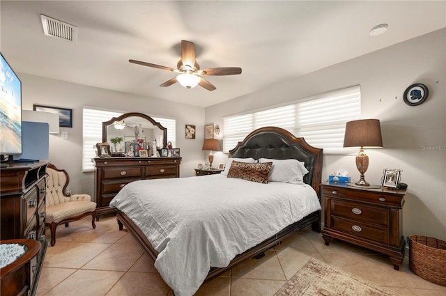 tiled bedroom featuring ceiling fan