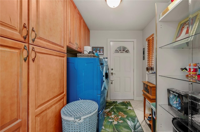 laundry area with cabinets, light tile patterned floors, and separate washer and dryer